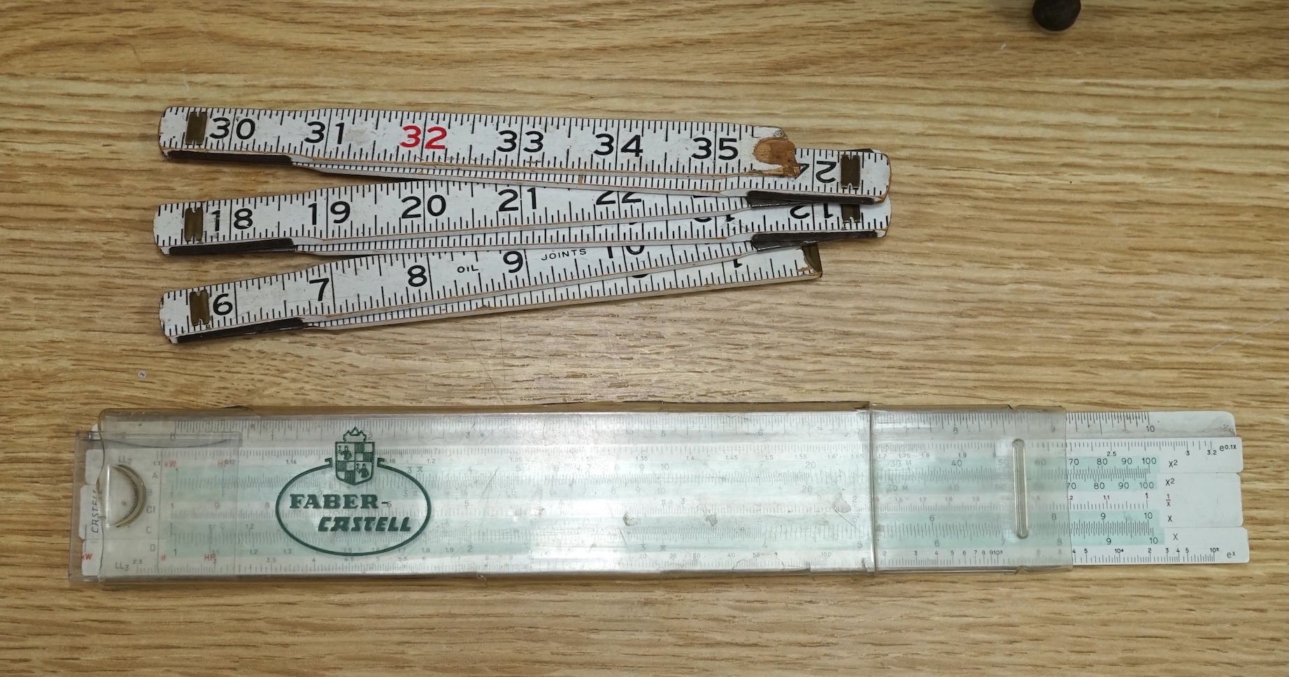 A collection of 19th and 20th century drawing instruments, including; levels, rulers, a set square etc. longest 79cm. Condition - variable, mostly fair to good